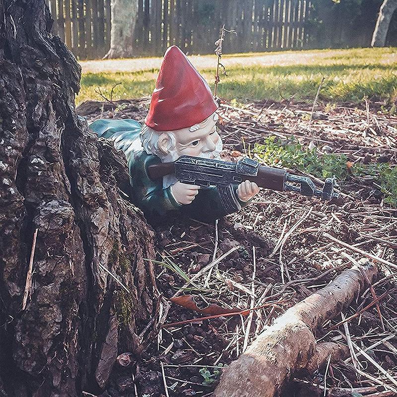 Garden gnome in camouflage with ak47